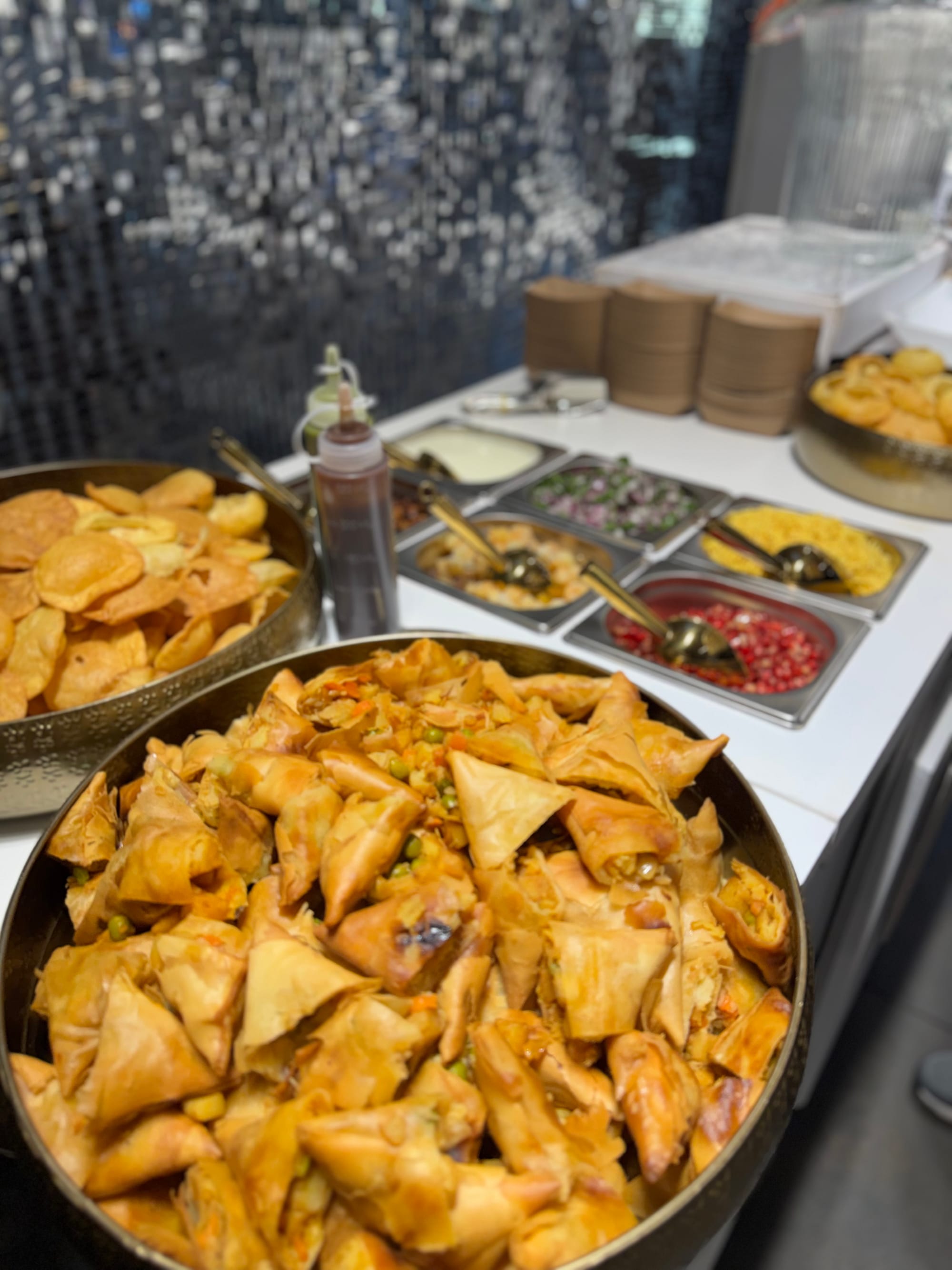 Trays of freshly fried samosas at the chaat counter