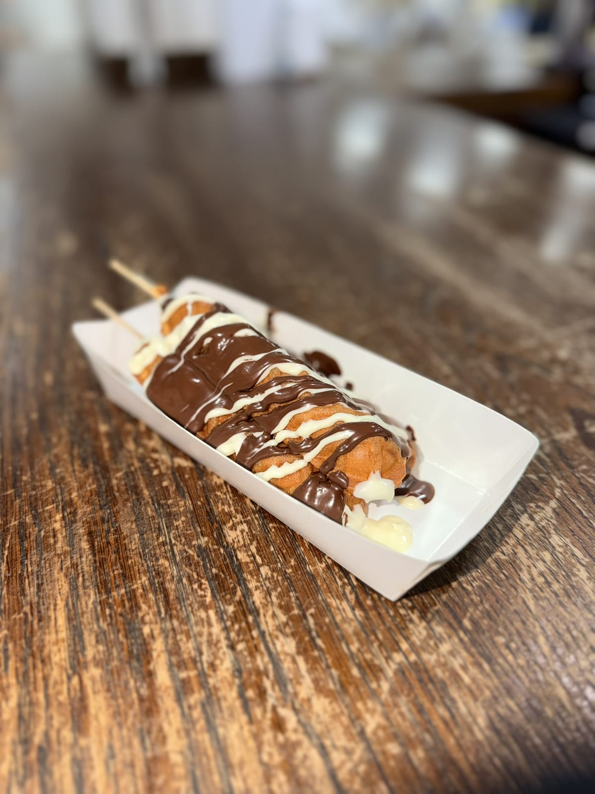Waffle on a stick with chocolate sauce from the Sweet St. waffle station